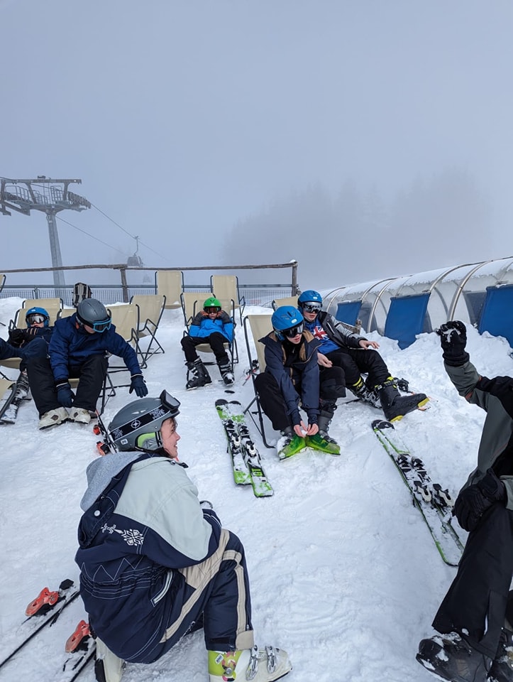 A group of students from Snowfields Academy are pictured preparing to ski down a snowy hillside during a school trip abroad.