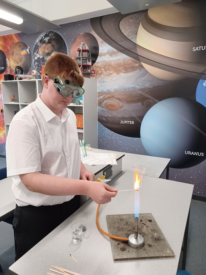 A student with a Bunsen burner