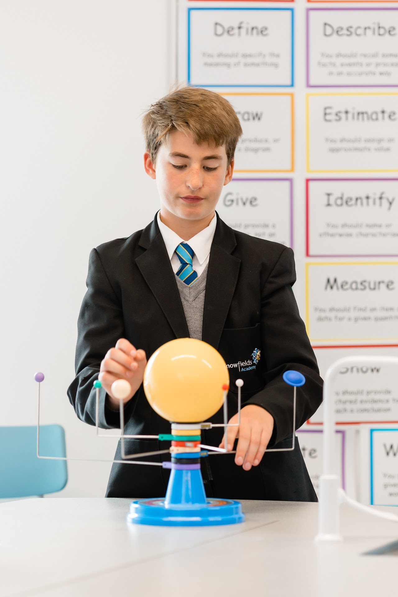 A student looking at a model solar system