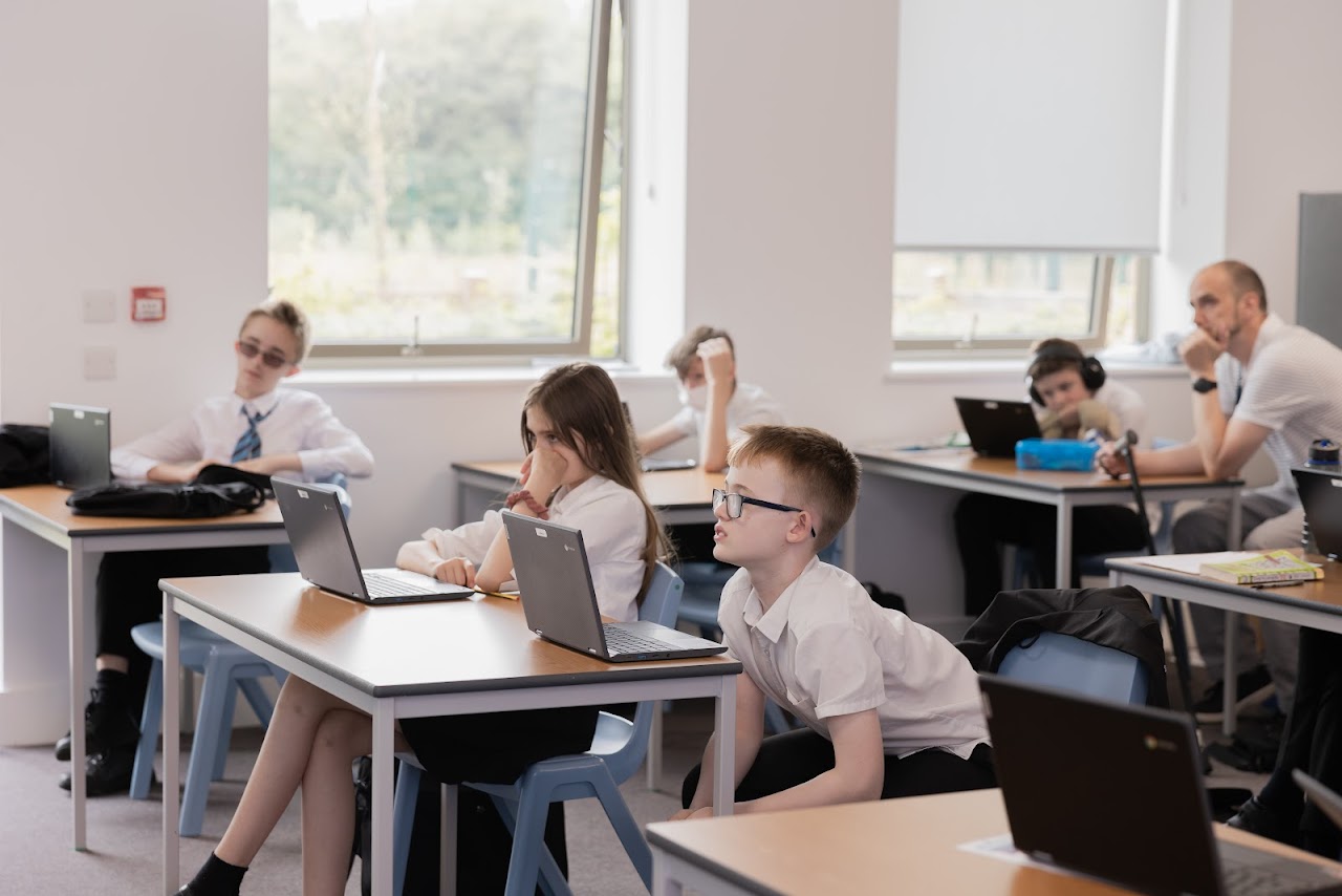 Students at desks with laptops
