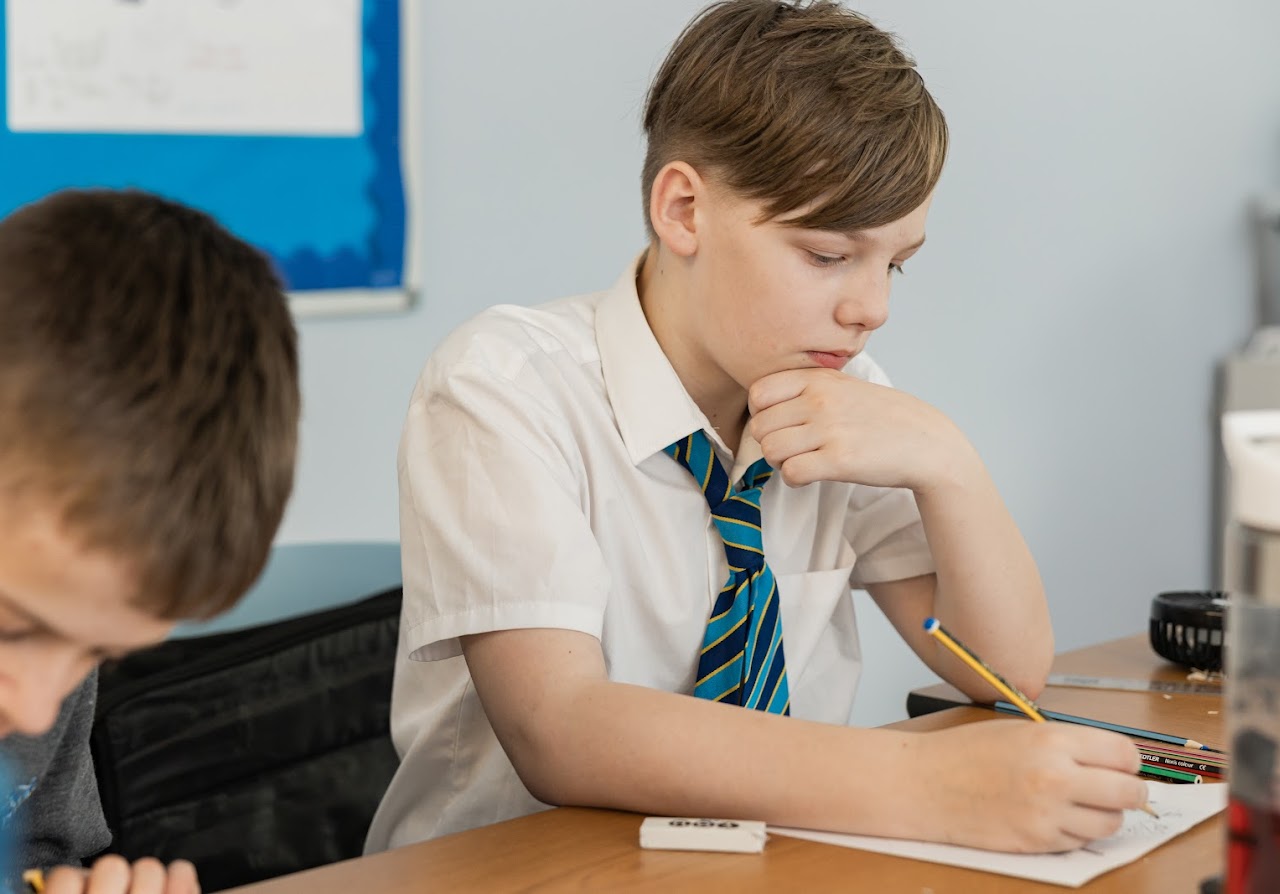A student at a desk writing